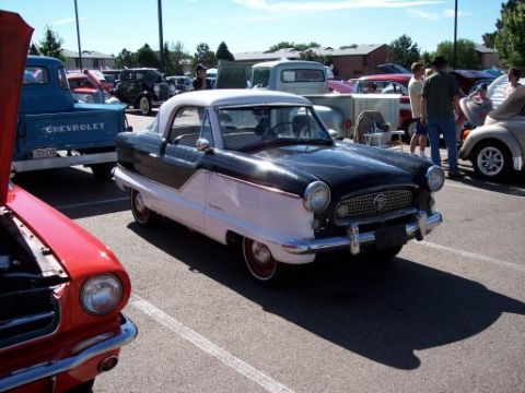 1972 Ford Ranchero - A Nash Metropolitan is displayed at a car show with multiple other vehicles present.