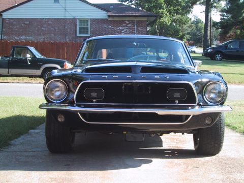 1968 Shelby GT500 - Front view of a black 1968 Shelby GT500, the distinctive Shelby badging on the grille.