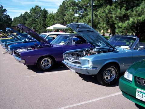 1972 Ford Ranchero - Several cars with hoods open are parked in a lot on a sunny day.
