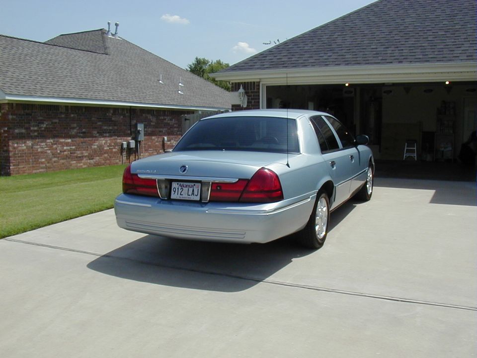 Light blue Mercury Grand Marquis sedan rear view in driveway with Arkansas plate 912 LAJ
