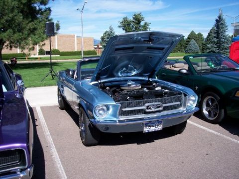 1972 Ford Ranchero - A light blue 1967 Ford Mustang convertible is parked with its hood open at an outdoor event.