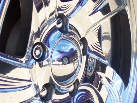 1972 Ford Ranchero - Reflection in a shiny chrome wheel shows a purple car with a sky reflection.
