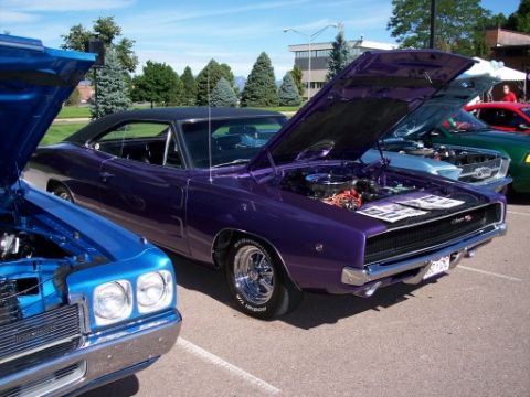 1972 Ford Ranchero - A purple 1968 Dodge Charger is displayed with its hood open at a car show.