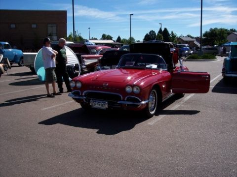 1972 Ford Ranchero - A red convertible is parked at a car show, with its driver's side door open and a license plate visible.