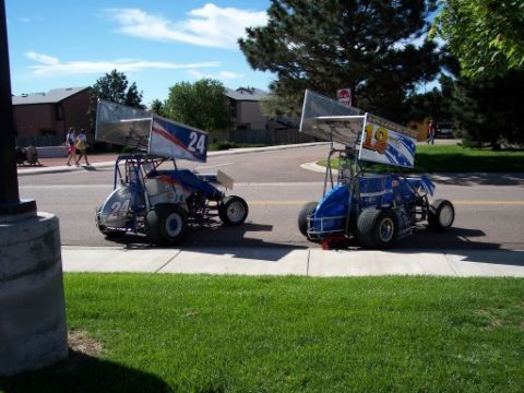 1972 Ford Ranchero - Two sprint cars, one with number 24 and the other with number 12, are parked on the side of a road.
