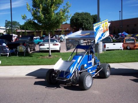 1972 Ford Ranchero - A blue sprint car is parked at an outdoor car show with other vehicles visible.