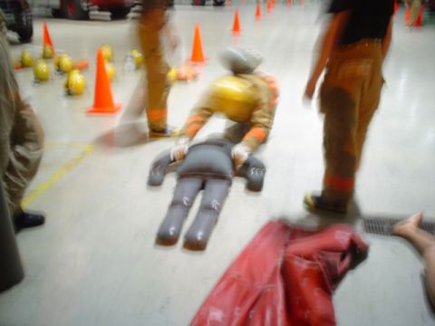 1981 Ford Bronco - Firefighters engage in a training exercise, practicing with a dummy on the floor of a facility.