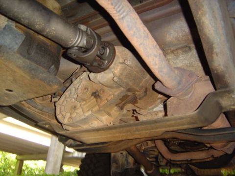 1989 Ford Ranger - Close-up of the drivetrain components and exhaust system underneath a vehicle.