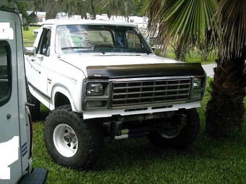 1986 Ford Bronco - This white Ford Bronco features a lifted suspension and a prominent grille.