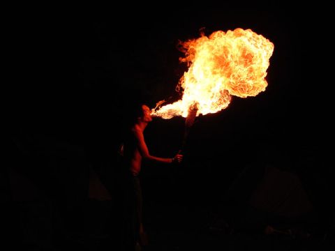 1991 Ford Probe - A performer breathes fire, creating a dramatic explosion of flames against a dark background.
