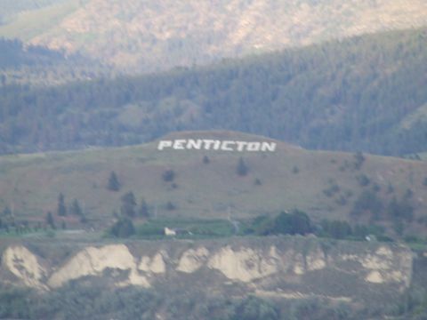 1990 Ford Bronco - Large white letters spell out PENTICTON on a grassy hillside.
