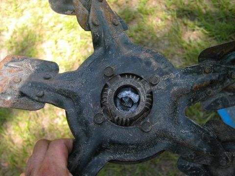 1986 Ford Bronco - A close-up view of a damaged fan clutch part, showing signs of rust and wear.