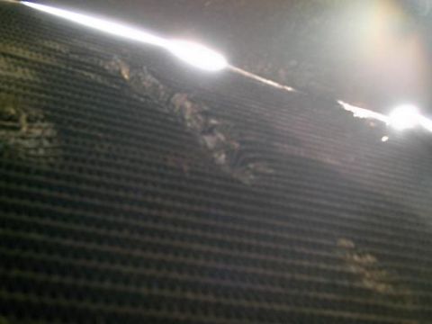 1986 Ford Bronco - Close-up of damaged radiator fins, showing debris accumulation.