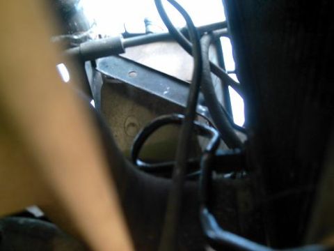 1986 Ford Bronco - Close-up view of engine bay components, showing hoses and metal structures.