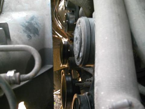 1986 Ford Bronco - Close-up view of engine pulleys and hoses, showing mechanical components.