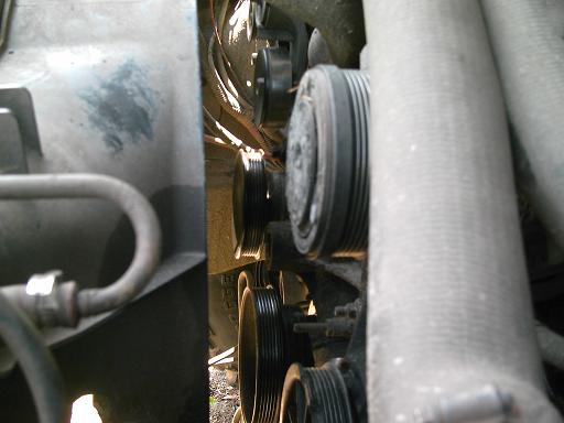 Engine pulleys and hoses, close-up view