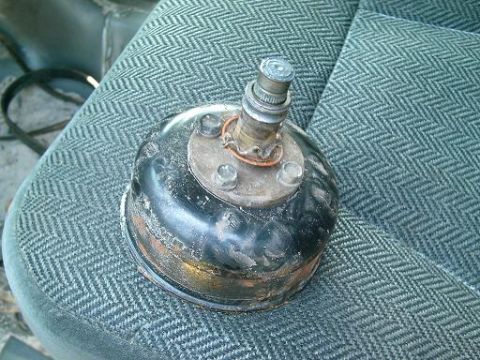 1986 Ford Bronco - A detached brake booster sits on a vehicle's seat, suggesting a repair or replacement.