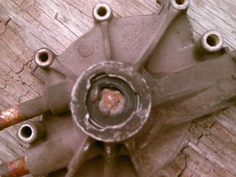 1986 Ford Bronco - A close-up view of a metal component, possibly from a vehicle, showing signs of rust and wear. A Ford logo is visible.