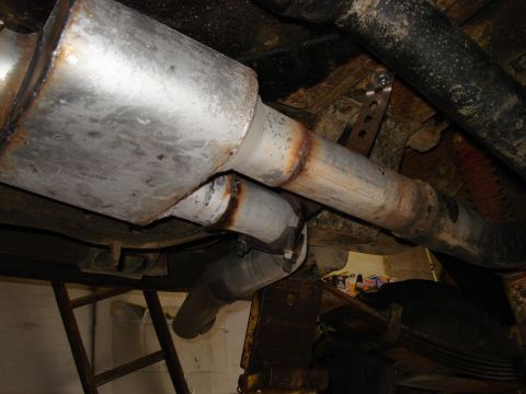 1994 Ford Bronco - Underside view of a vehicle's exhaust system, showing the muffler and piping.