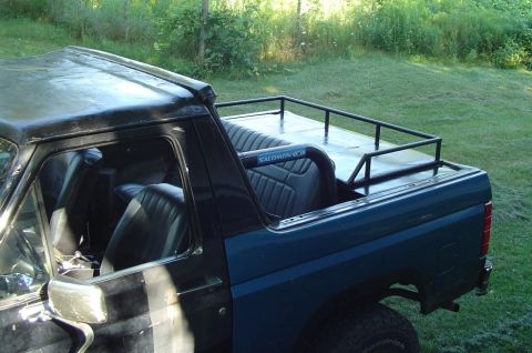 1986 Ford Bronco - This Ford Bronco has a custom top and a roll bar installed in the bed area.