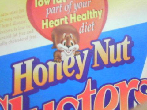 1990 Ford Bronco - Close-up of a Honey Nut Clusters cereal box the Honey Nut squirrel mascot and nutritional information.