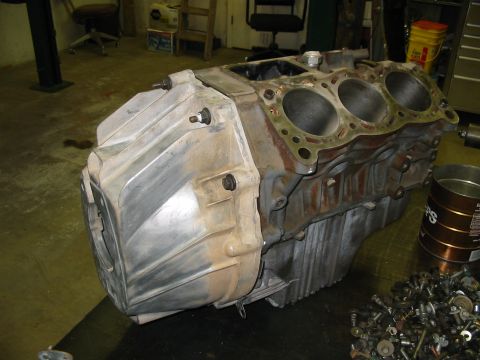 1993 Ford Taurus - Engine block and transmission housing assembly shown in a workshop setting.