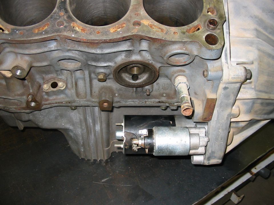 Close-up of an engine block and starter motor assembly