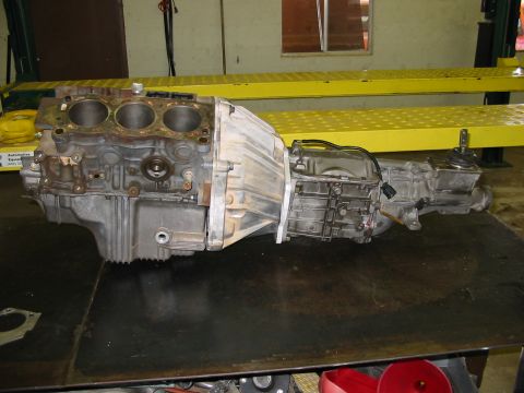 1993 Ford Taurus - Engine block and transmission assembly removed from a vehicle.