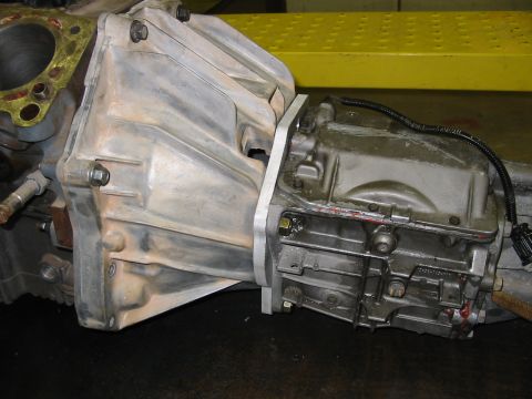 1993 Ford Taurus - Close-up view of a car's transmission assembly, showing the bell housing and various mechanical components.