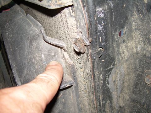 1978 Ford Bronco - Broken fan shroud from tree impact. Also, the radiator tank support (?), which is usually soldered to the radiator, was also broken loose.