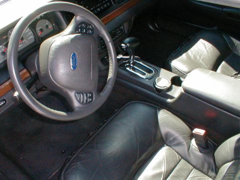2002 Ford Crown Victoria - Interior view of a 2002 Ford Crown Victoria, highlighting the dashboard and seating.