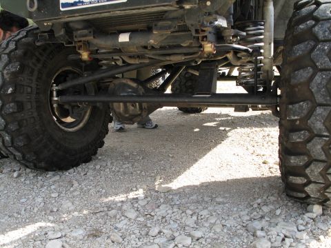 1995 Ford Bronco - Close-up view of the undercarriage and suspension system of an off-road vehicle.
