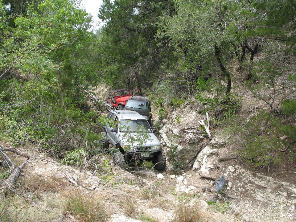 Silver SUV on rocky trail, 2000s model
