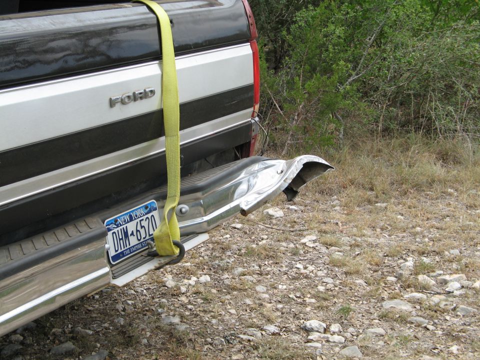 Ford pickup truck rear bumper with New York license plate DHM-6520 and yellow strap
