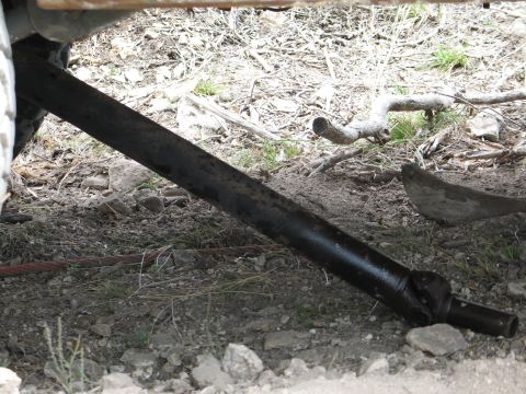 1995 Ford Bronco - Undercarriage view showing a driveshaft and surrounding terrain.