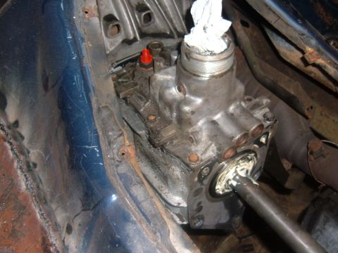1985 Ford F-150 - Close-up of a vehicle's transmission housing, showing internal components and a metal rod.