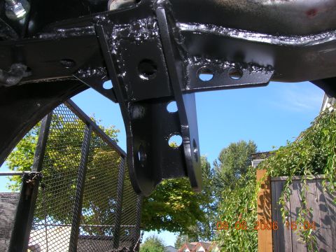 1996 Ford Bronco - Close-up of a black suspension bracket, likely part of an aftermarket modification, with a date stamp of 09-06-2006 visible.