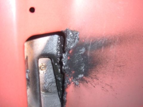 1985 Ford F-150 - This photo shows a close-up of a vehicle's body panel with a metal bracket and sealant, indicating repair work.