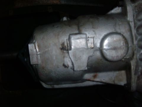 1985 Ford F-150 - Close-up of a transmission housing, with a watermark for "SUPERMOTORS.NET" visible at the bottom right.