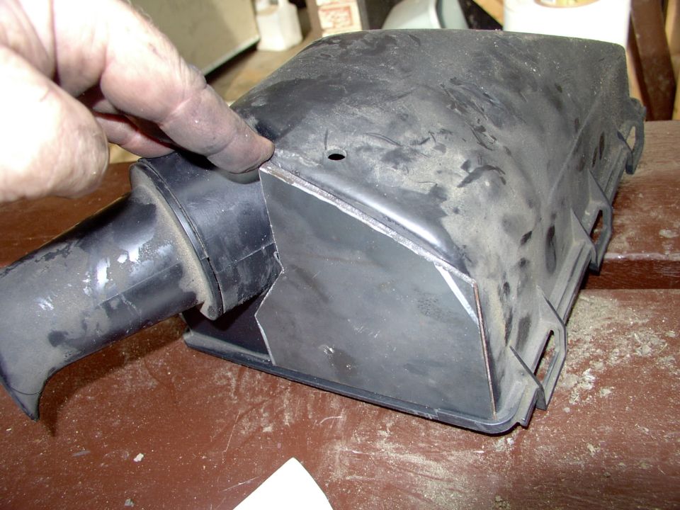 Plate ready to accept tubing (once a hole is cut into it).The small hole in the airbox is the drain hole (remember this is the bottom of the airbox so "it" is upside down in the pic).