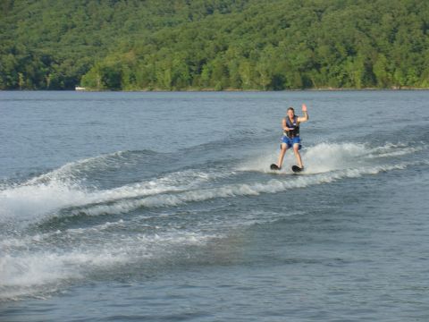 1988 Ford Bronco - Waterskier waves while being pulled across a lake.
