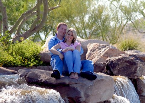 1991 Ford Bronco - A couple poses for a photo while sitting on large rocks next to a flowing water feature.