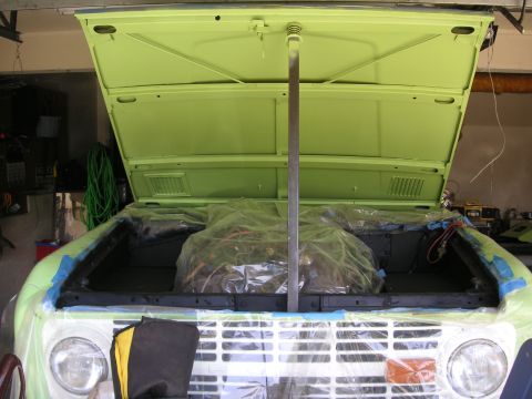 1999 Jeep Grand Cherokee - The engine bay of a vintage SUV is prepped for work, with the engine covered for protection.