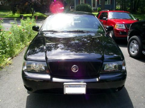 2003 Mercury Marauder - Front view of a black 2003 Mercury Marauder parked in a driveway, with other vehicles visible.