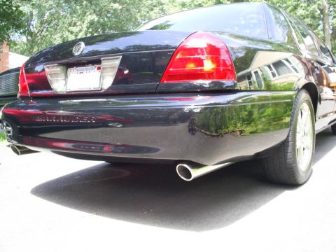 2003 Mercury Marauder - Rear view of a black 2003 Mercury Marauder sedan, showing its distinctive taillights and dual exhaust pipes.