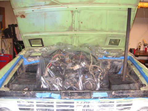 1999 Jeep Grand Cherokee - The engine compartment is covered in plastic sheeting, obscuring the engine details.