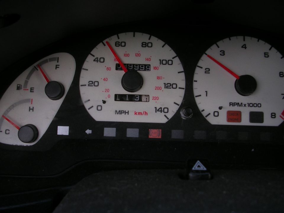 Car dashboard with speedometer reading 40 mph and odometer showing 199999 miles