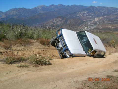 1985 Ford Bronco - This vehicle appears to be stuck on a steep incline, with its tires off the ground.