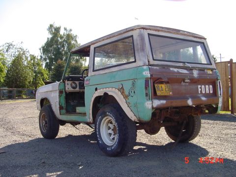 1991 Ford Explorer - This vintage Ford Bronco appears to be in a state of disrepair, with its driver's side door removed and significant rust on the rear tailga…