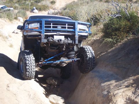 1985 Ford Bronco - Modified 1992 Ford Bronco tackling an off-road obstacle.